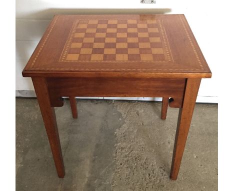 An inlaid light wood games table.  Approx  58cm x 46 cm x 59cm tall.