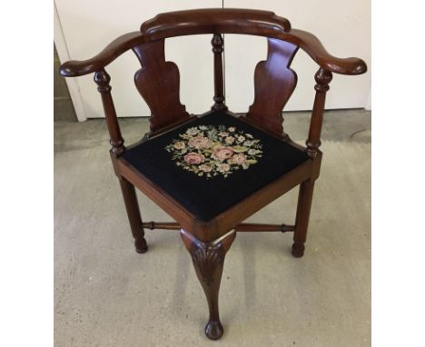 A late Victorian corner chair. With curved back and black tapestry seat decorated with flowers. 