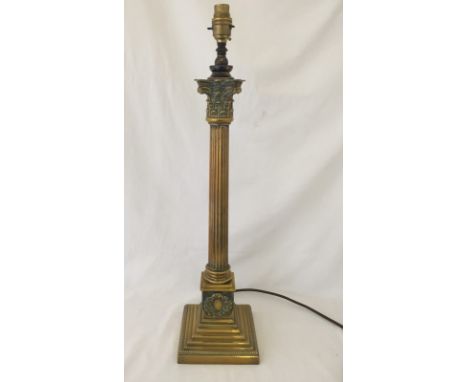 A brass column style lamp base with orange lamp shade.  63cm tall to top of fitting.