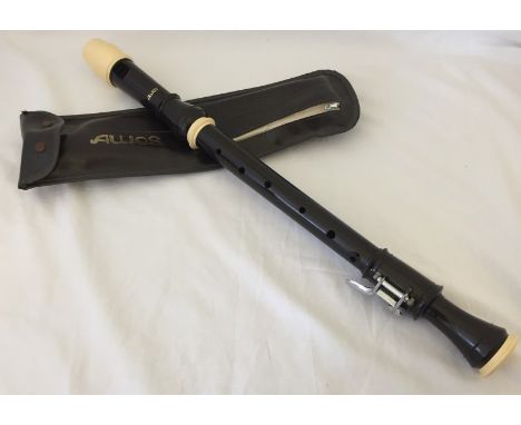 A cased tenor recorder.  