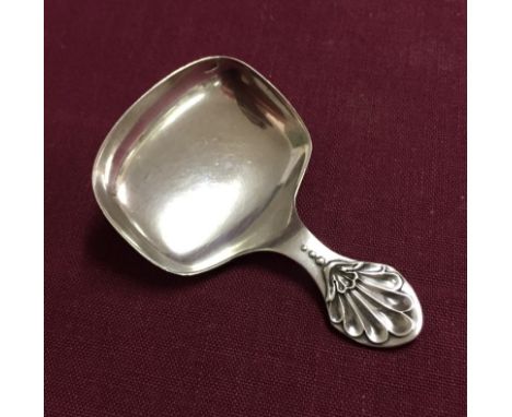 A silver tea caddy spoon with shell design to handle. Hallmarked Sheffield 1918 and made by Cooper Bros & Sons. 