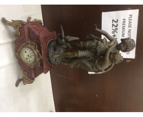 A 19th century mantel clock with brass mounts and spelter figures of two children and a duck 