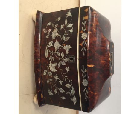 A 19th century tortoiseshell tea caddy with mother-of-pearl floral inlay