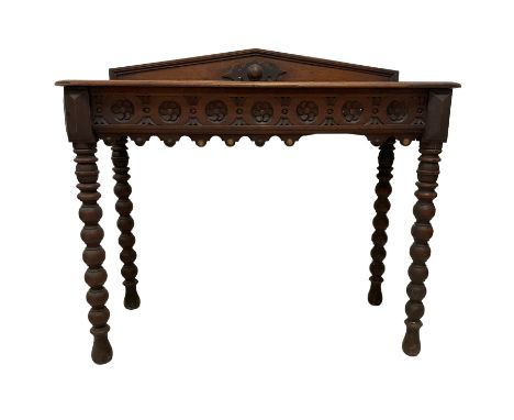 Late 19th century carved oak console or side table, raised arched back, the frieze carved with repeating rosettes, raised on 