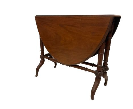 Late 19th century mahogany drop leaf table, raised on turned supports united by stretcher with roundel carvings, on ceramic c