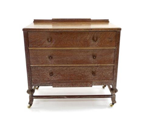 Heals style limed oak chest of drawers, the raised stylised back over three long drawers with stylised apron and supports, up