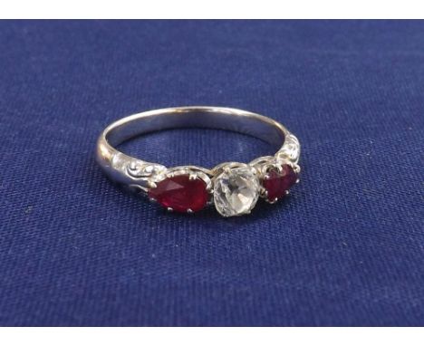 18ct white gold ruby and diamond three stone ring, with an old-cushion-cut centre stone, estimated 0.33ct, flanked by two rub