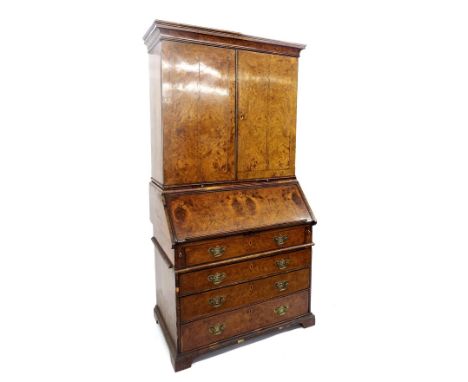 Fine early 18th century burr walnut bureau cabinet, the raised twin doors enclosing a fully fitted interior with pigeonholes,