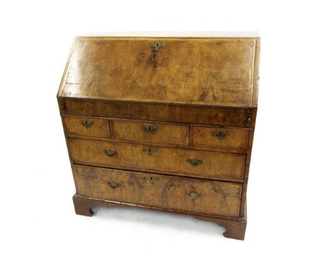 18th century burr walnut veneered bureau, the crossbanded fall front enclosing a fitted interior and well with sliding cover,