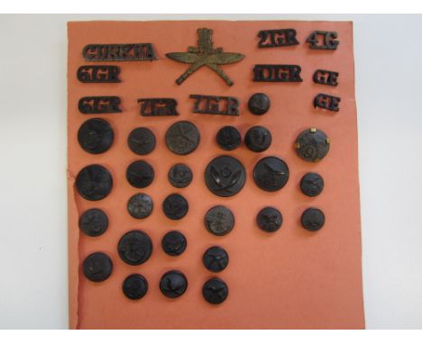 Indian Army. Gurkha Insignia,a carded display of mainly buttons and s/titles, but including a cap badge of the 1st King Georg