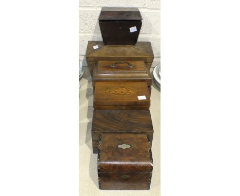 A 19th century mahogany tea caddy of sarcophagus form, fitted with a central aperture for mixing bowl, flanked by lidded tea 