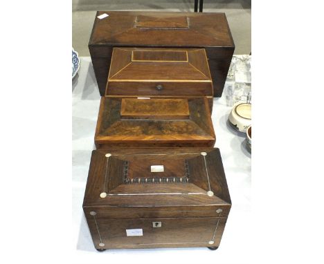 A 19th century mahogany sarcophagus-shaped tea caddy with fitted aperture for mixing bowl, flanked by two tea cannisters, 35.