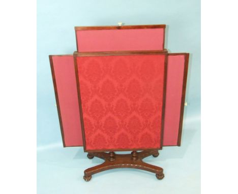 A George IV mahogany fire screen with extending side and top panels, on concave platform with beaded borders and half-gadroon