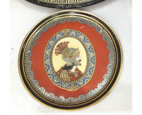 A circular ceramic dish decorated with the head of a Roman centurion, various 'Roman' busts, Greek ceramics, etc. 