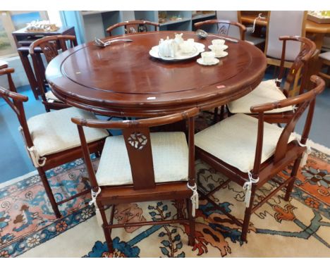 A modern Chinese hardwood dining table with a bamboo style column and a matching set of eight chairsLocation: LAM 