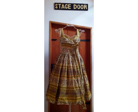 A 1950's Horrockses sleeveless, lime green, yellow and brown knee length dress with underskirt, side bow and sash, UK size 12