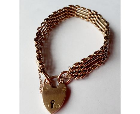 A 9ct gold gate-link bracelet with heart shaped locket, makers initials J.C & S, stamped 9ct, g.Location: Cab 