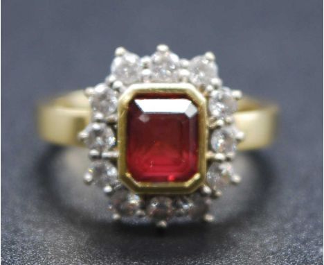 An 18ct yellow and white gold, tourmaline and diamond rectangular cluster ring, featuring a step cut red tourmaline within a 