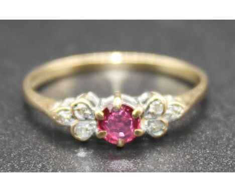 A 9ct gold ruby and diamond point dress ring, the six claw set round cut ruby weighing approx 0.2ct, sponsor SJ, 1.2g, size L