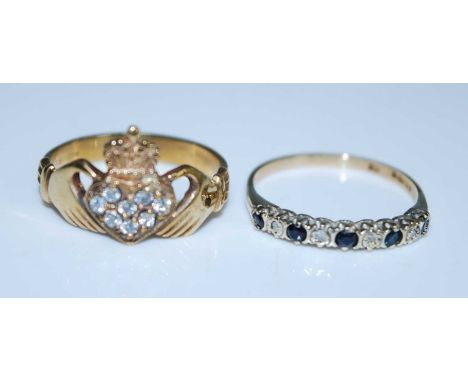 Two 9ct yellow gold rings. A 9ct yellow gold claddaugh ring with eight round facetted white sapphires set in the centre. Sapp