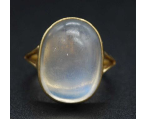 A vintage yellow metal moonstone set dress ring, the cabochon moonstone measuring 20 x 15 x 8mm, to a yellow metal band with 