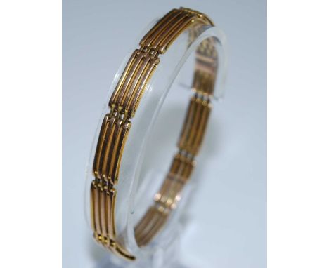A yellow metal four bar gate link bracelet with integral box clasp and figure of eight safety catch. Length 190mm, width 8.0m