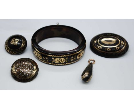 A Victorian gold and silver pique tortoiseshell bangle, with elastic centre, dia.6.5cm; together with three various gold and 