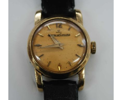 A lady's vintage Jaeger LeCoultre 9ct gold cased wristwatch, having a signed champagne dial (discoloured), baton markers, and