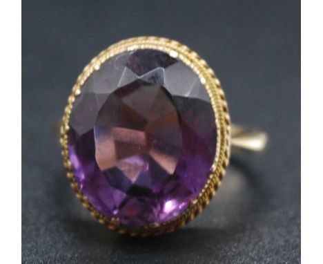 A vintage 9ct gold amethyst dress ring, the oval cut amethyst measuring approx 15 x 13 x 8mm, 5.5g, size I/JSome very minor s