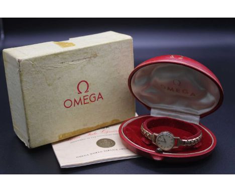 A vintage Omega ladies 9ct gold cased bracelet watch having a signed champagne dial with baton markers, manual wind movement 