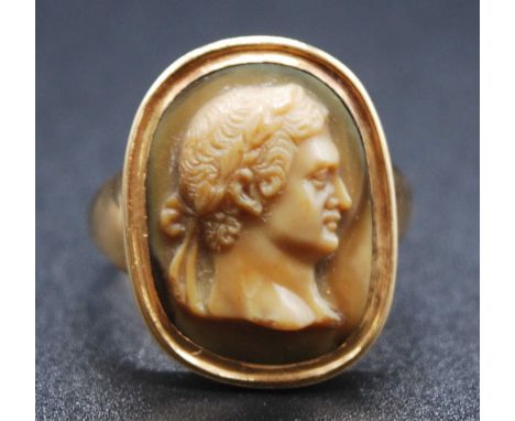 A yellow metal carved Lava Stone cameo ring depicting the bust of a Roman emperor, approx 17.5 x 13.1mm, size M½, gross weigh