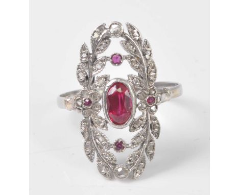 A white metal, synthetic ruby and diamond openwork panel ring, featuring a centre oval faceted ruby within a foliate border s