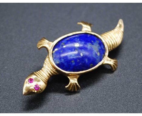 A middle-eastern yellow metal lapis lazuli set brooch, in the form of a turtle, having ruby(?) set eyes, with Arabic markings