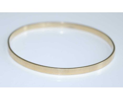 A modern 9ct gold bangle, undecorated, sponsor CG&amp;S, 11.8g, 6.5cmInternal dia approx. 6.5cm; it is misshapen but not bent