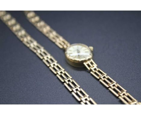 A ladies 9ct gold cased manual wind dress watch, having a champagne dial signed Geneve Gold and with baton markers to integra