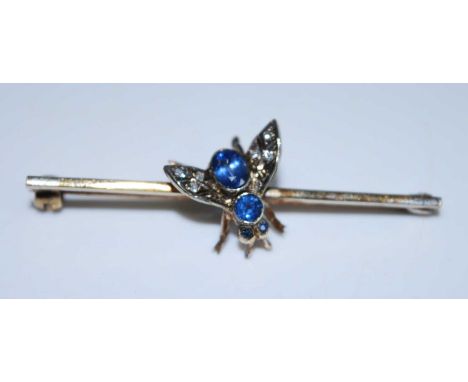A 9ct yellow gold sapphire and diamond insect bar brooch featuring 3 round sapphires for the eyes and thorax and an oval sapp
