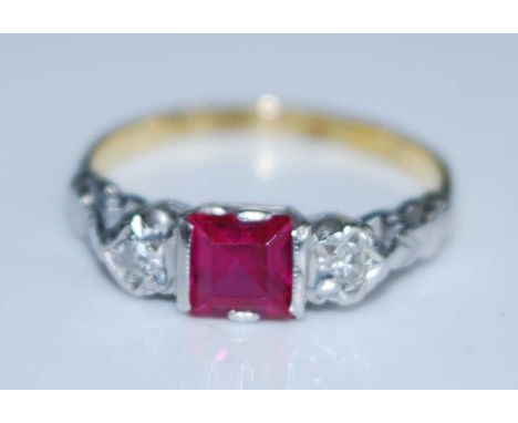 A yellow and white metal, synthetic ruby and diamond three stone ring, the centre square cut ruby measuring approx 4.6 x 4.4 