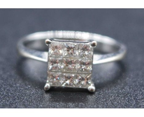 A white metal diamond square cluster ring, featuring nine Princess cut diamonds in invisible settings, diamond dimensions eac