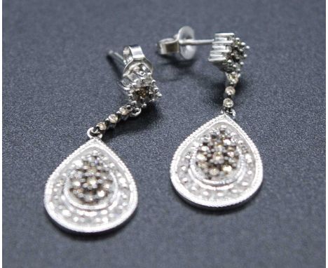 A pair of 9ct white gold and diamond pear shaped cluster drop earrings, each with fifteen fancy light brown and twenty-six si