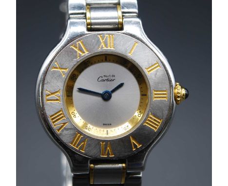 A lady's Must de Cartier bi-metal dress watch, having signed silvered dial within a Roman bezel, cabochon sapphire set crown,