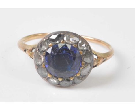 An early 19th century yellow and white metal, sapphire and diamond circular cluster ring, comprising a centre round faceted s
