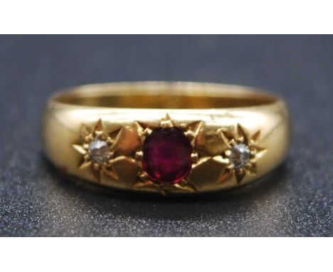 An 18ct yellow gold, ruby and diamond dress ring, featuring a centre oval faceted ruby with an Old European cut diamond to ei