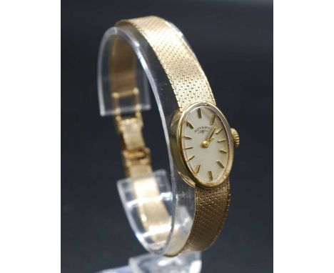A lady's Rotary 9ct gold cased manual wind dress watch, having signed silvered oval dial with baton markers, case dia.16mm, t
