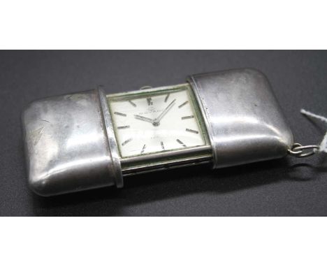 A Movado Turler white metal cased purse watch having signed silvered dial with baton markers (lacking hide cover to case), wi