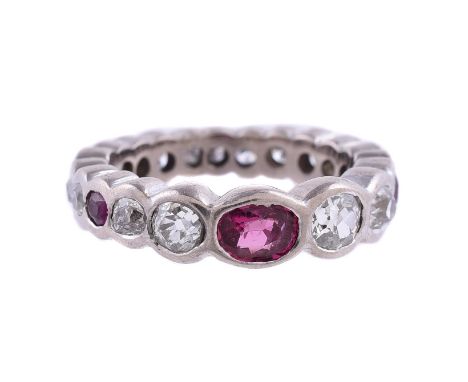 
	
		AN 18 CARAT GOLD RUBY AND DIAMOND ETERNITY RING 
		LONDON 2005
		The ring set with an oval cut ruby and two further circ