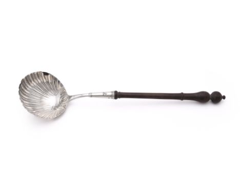 
	
		A GEORGE III SILVER LADLE
		GEORGE SMITH (III), LONDON 1769
		With a turned wood handle, engraved with a crest and a she
