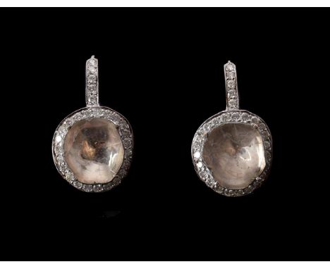 
	
		A PAIR OF POLKI DIAMOND EARRINGS 
		The polki diamonds within a surround of brilliant cut diamonds, with shepherds hook 