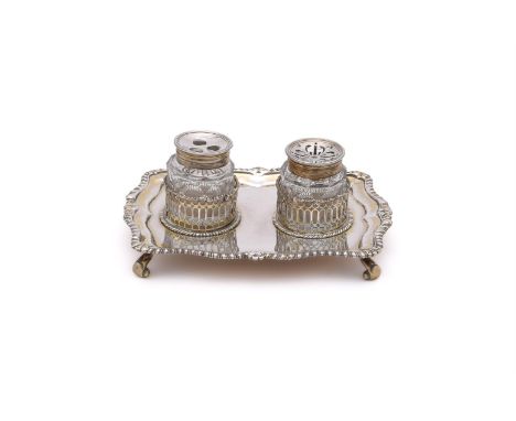 
	
		A BRITANNIA STANDARD SILVER INK STAND 
		MARKS OBSCURED
		With a shaped gadrooned border, two circular pierced frames wi
