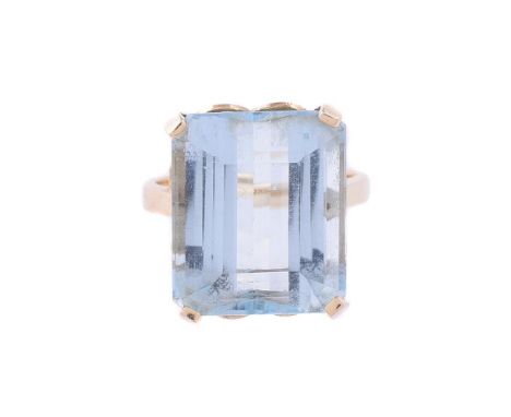 
	
		AN AQUAMARINE DRESS RING
		The step cut aquamarine with canted corners, estimated to weigh 12.43 carats, to a gold colou