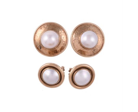
	
		TWO PAIRS OF MABÉ PEARL EAR CLIPS
		The first pair with a mabé pearl within a 9 carat gold hammered surround, London 199